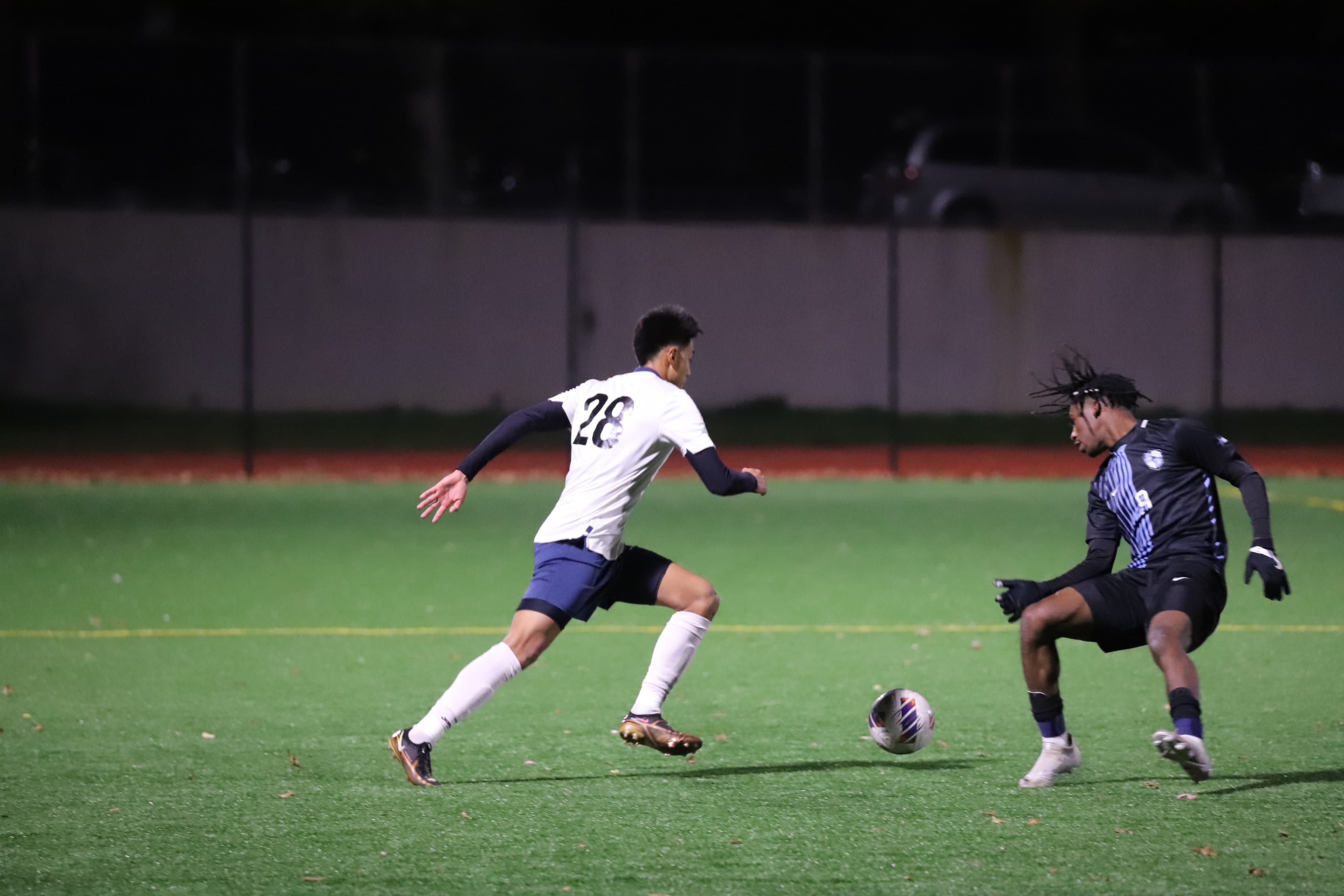 Pepe in white kit running on green turf under stadium lights