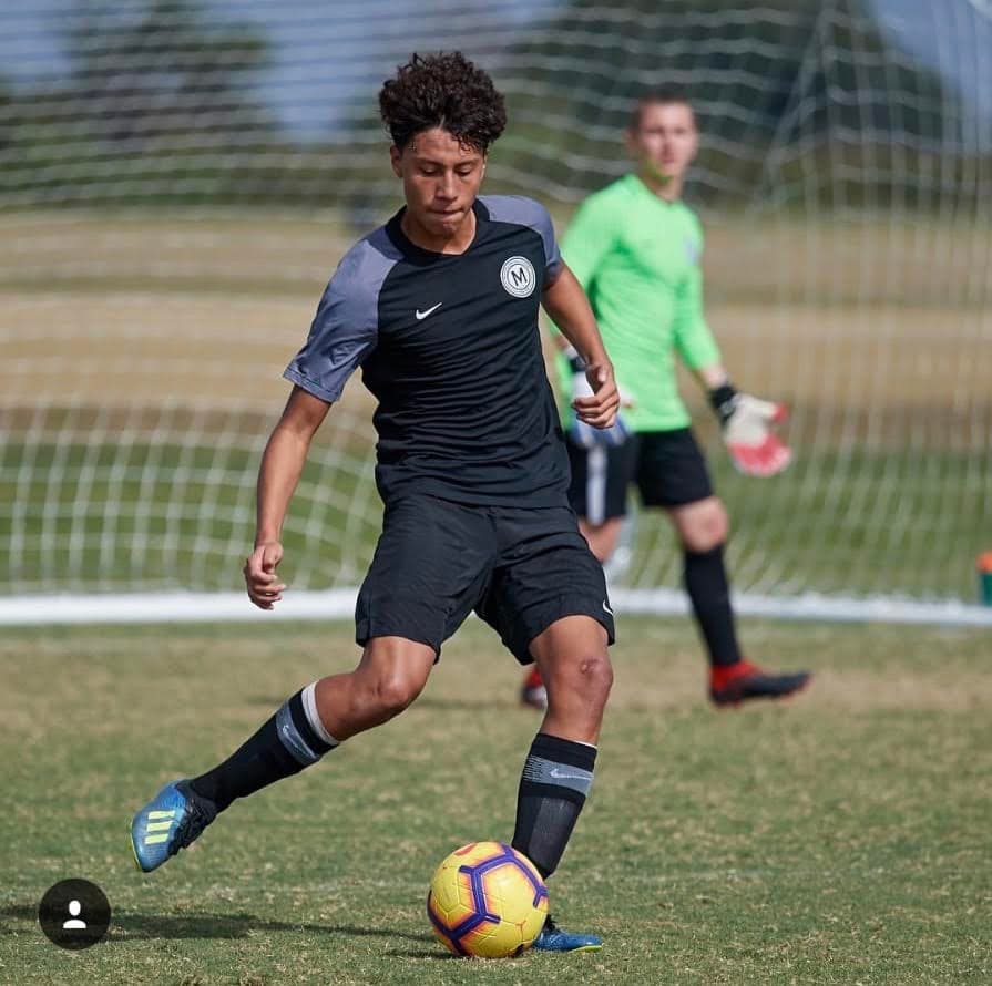 Teen Pepe in Metropolitan Oval Academy kit striking the ball