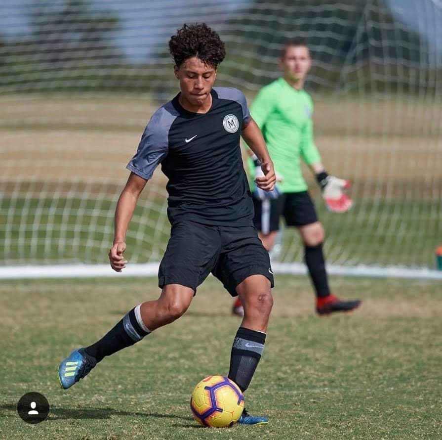 Teen Pepe in Metropolitan Oval Academy kit striking the ball